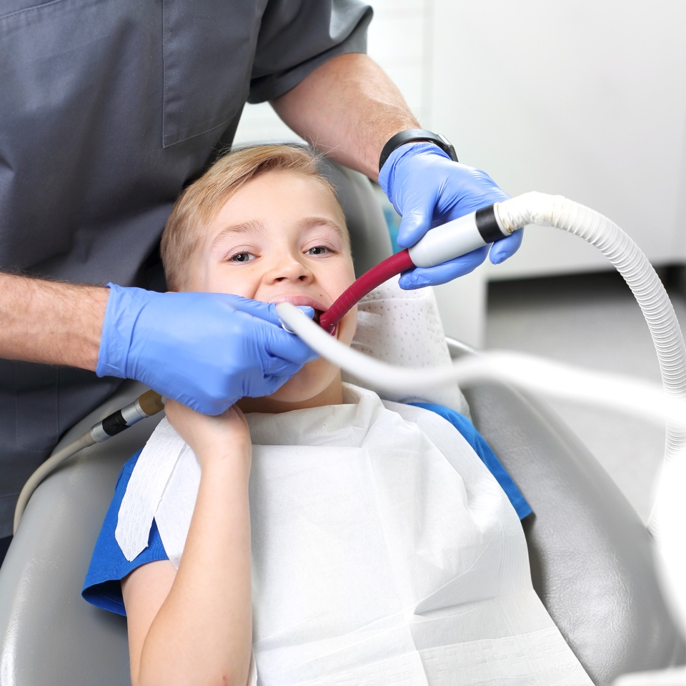 child dentist tooth treatment dentist cleans cavity